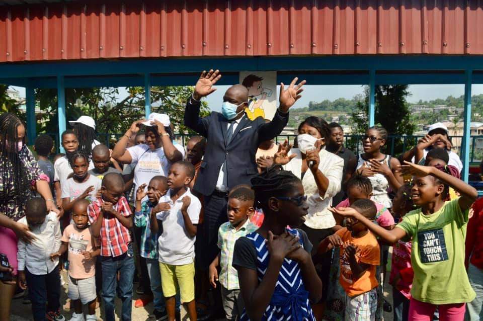Le DG de la CNAMGS et la directrice de Mot A Mot posant avec les enfants bénéficiaires de la prise en charge