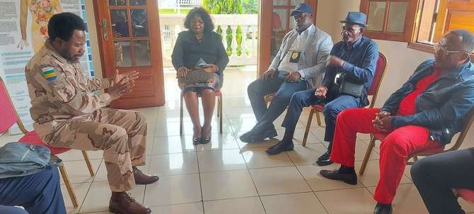 Le vice-président de la Conacce Chaplains, le Capitaine Max Alexandre Ngoua parlant au Dr Louma vêtu de rouge
